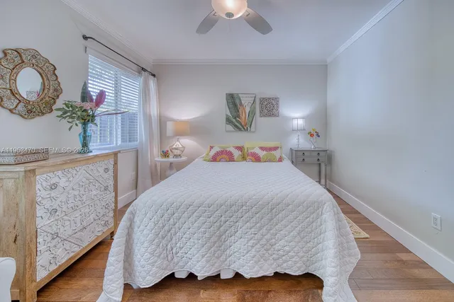 a bedroom with a bed and a lamp with wooden floor