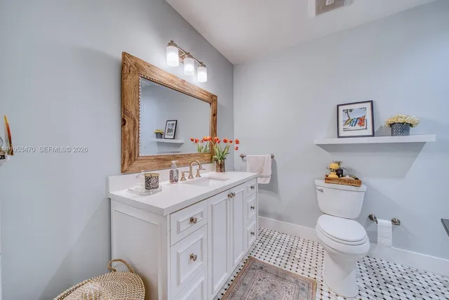a bathroom with a sink toilet vanity and tub