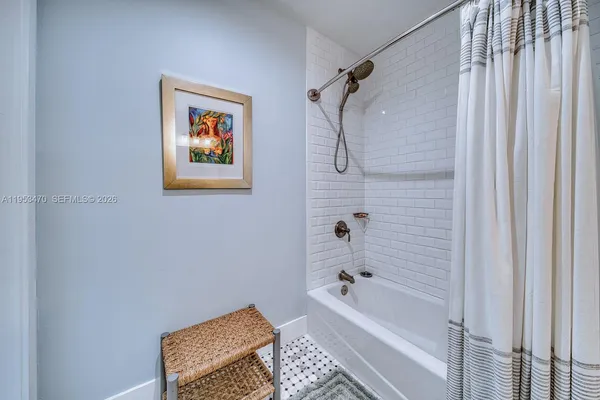 a bathroom with a bathtub and a shower