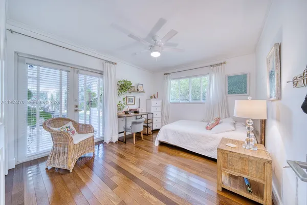 a bedroom with furniture and a wooden floor