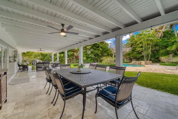 a view of a patio with a table chairs and a backyard