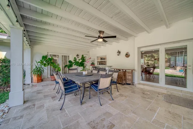 a view of a dining room with furniture and a potted plant
