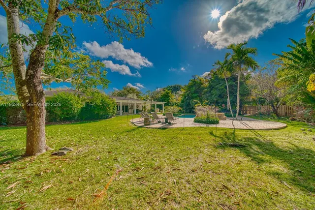 a view of a house with backyard porch and sitting area