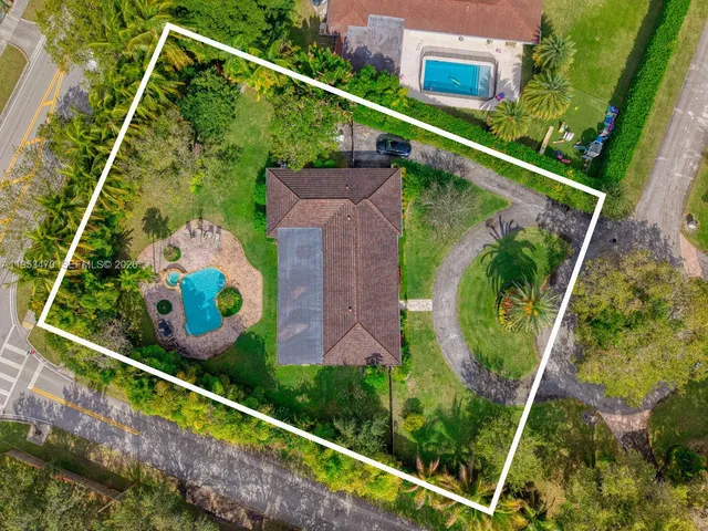 an aerial view of a house with a yard