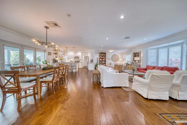 a living room with furniture or kitchen view and a wooden floor