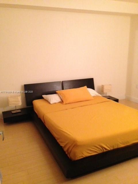 2740 Southwest 28th Terrace, Unit 304 Miami, FL 33133 - Photo 3 of 13 a bedroom with a bed and a night stand