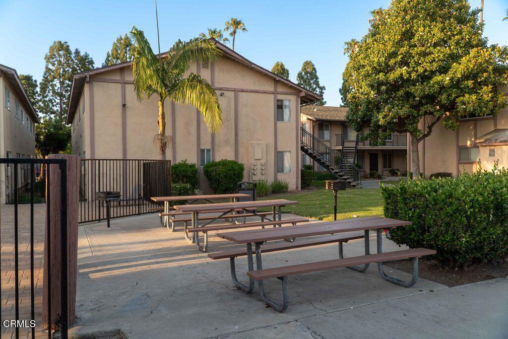 1925 Ginger Street, Unit 104 Oxnard, CA 93036 - Photo 17 of 25 a backyard of a house with fountain table and chairs
