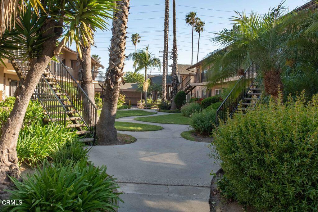 1925 Ginger Street, Unit 104 Oxnard, CA 93036 - Photo 2 of 25 a view of a garden with a tree
