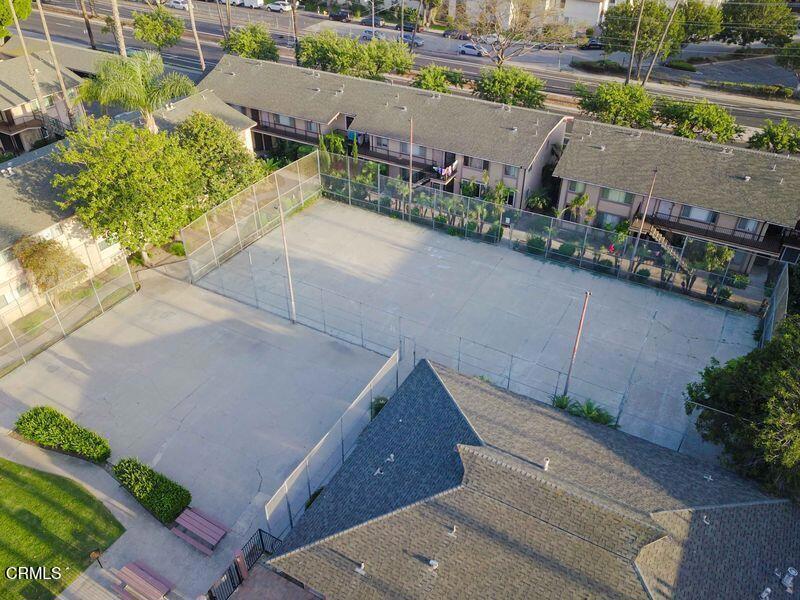 1925 Ginger Street, Unit 104 Oxnard, CA 93036 - Photo 22 of 25 an aerial view of a house with a yard and a garage