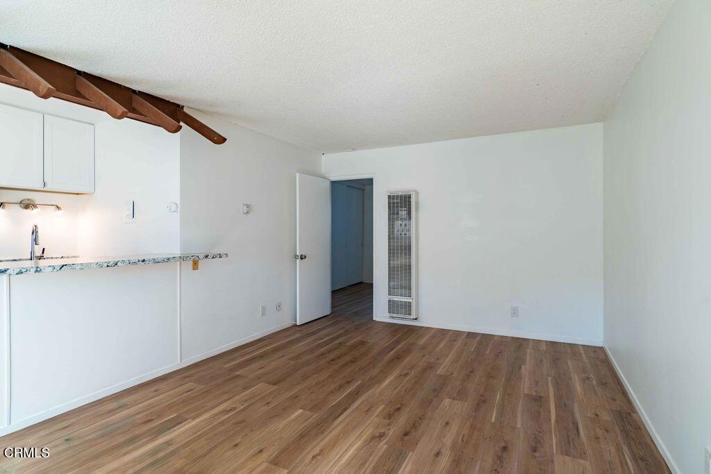 1925 Ginger Street, Unit 104 Oxnard, CA 93036 - Photo 6 of 25 a view of hallway with wooden floor