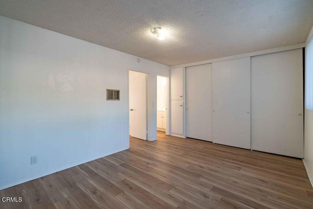 1925 Ginger Street, Unit 104 Oxnard, CA 93036 - Photo 9 of 25 a view of an empty room with wooden floor