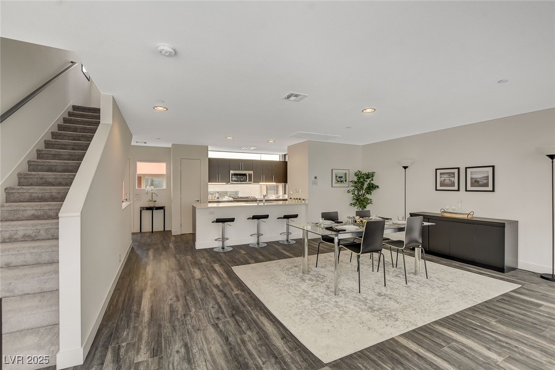 1998 Lewis Avenue Las Vegas, NV 89101 - Photo 15 of 48 A seamless kitchen-dining space is complemented by a view of the staircase to the upper level.