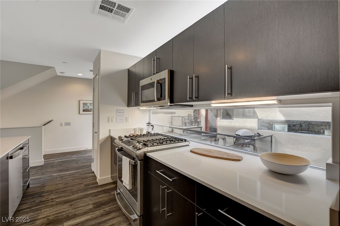 1998 Lewis Avenue Las Vegas, NV 89101 - Photo 26 of 48 The kitchen blends style and function with stainless steel appliances, quartz countertops, and space for a fridge.