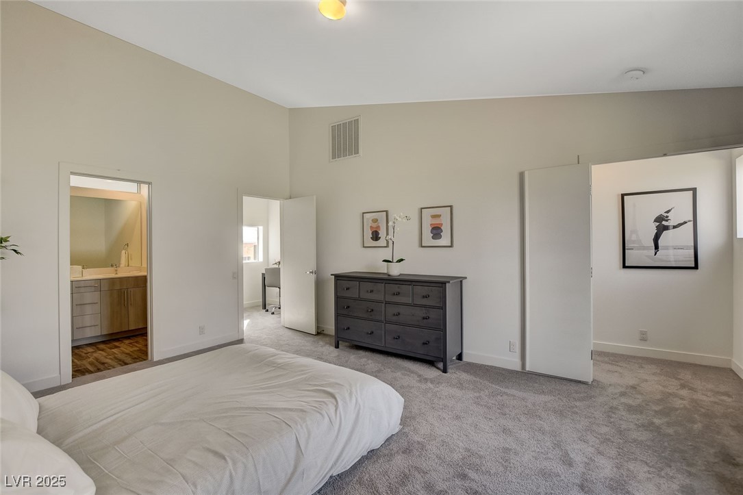 1998 Lewis Avenue Las Vegas, NV 89101 - Photo 30 of 48 The primary bedroom combines space and style with big windows, a walk-in, and a dual-vanity ensuite.