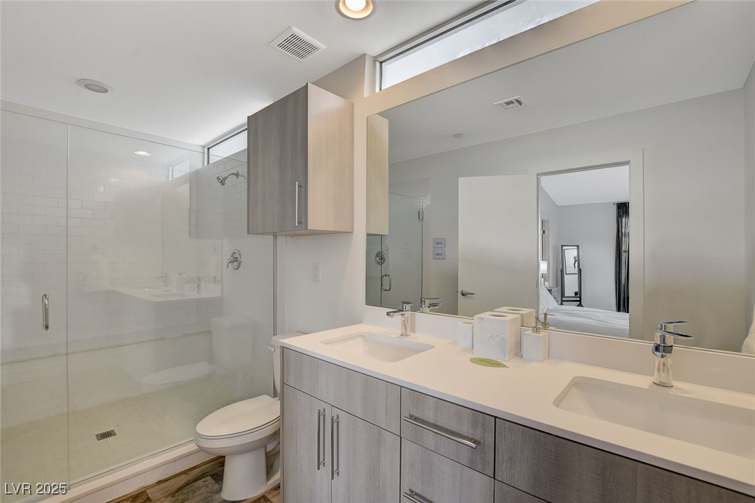 1998 Lewis Avenue Las Vegas, NV 89101 - Photo 33 of 48 Clean lines and contemporary finishes define this ensuite, complete with dual sinks and a large walk-in shower!