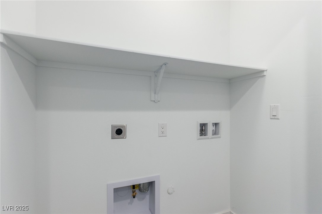 1998 Lewis Avenue Las Vegas, NV 89101 - Photo 36 of 48 This laundry area offers both convenience and organization with shelves and washer/dryer hookups.