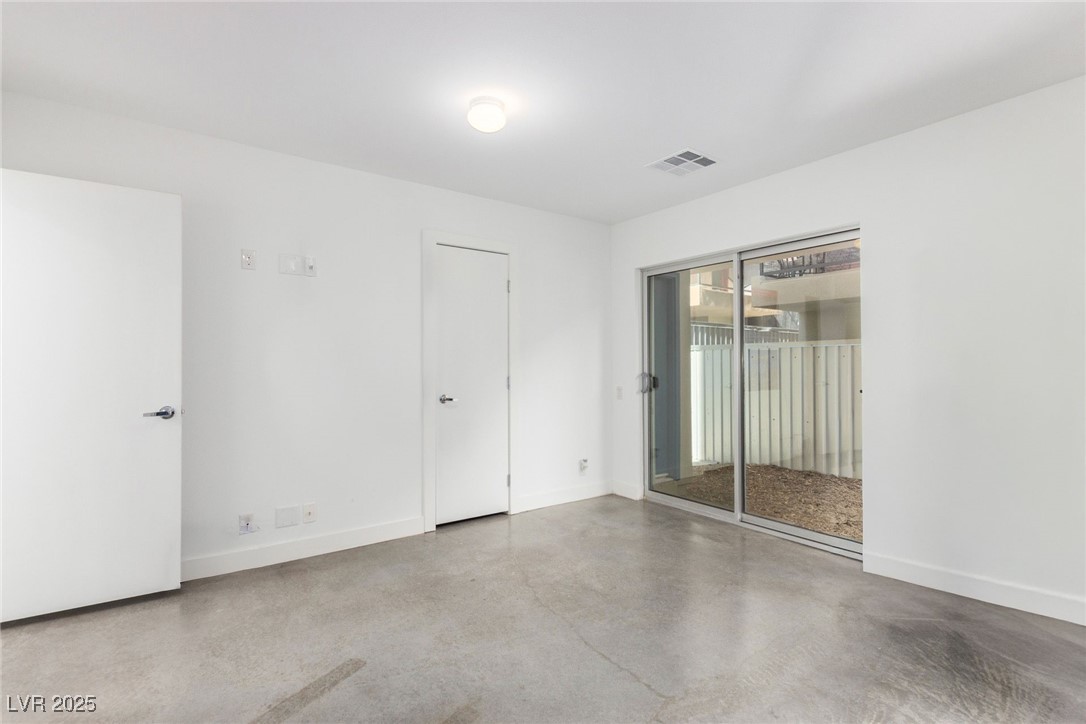 1998 Lewis Avenue Las Vegas, NV 89101 - Photo 6 of 48 A ground-floor bedroom with sliding doors creates a seamless indoor-outdoor flow.