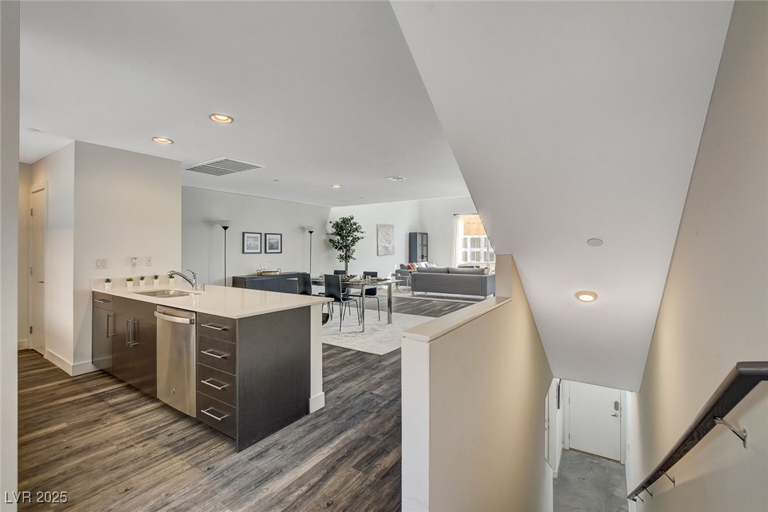 1998 Lewis Avenue Las Vegas, NV 89101 - Photo 10 of 48 The middle floor opens up with vaulted ceilings and luxury plank flooring that feels both spacious and inviting.
