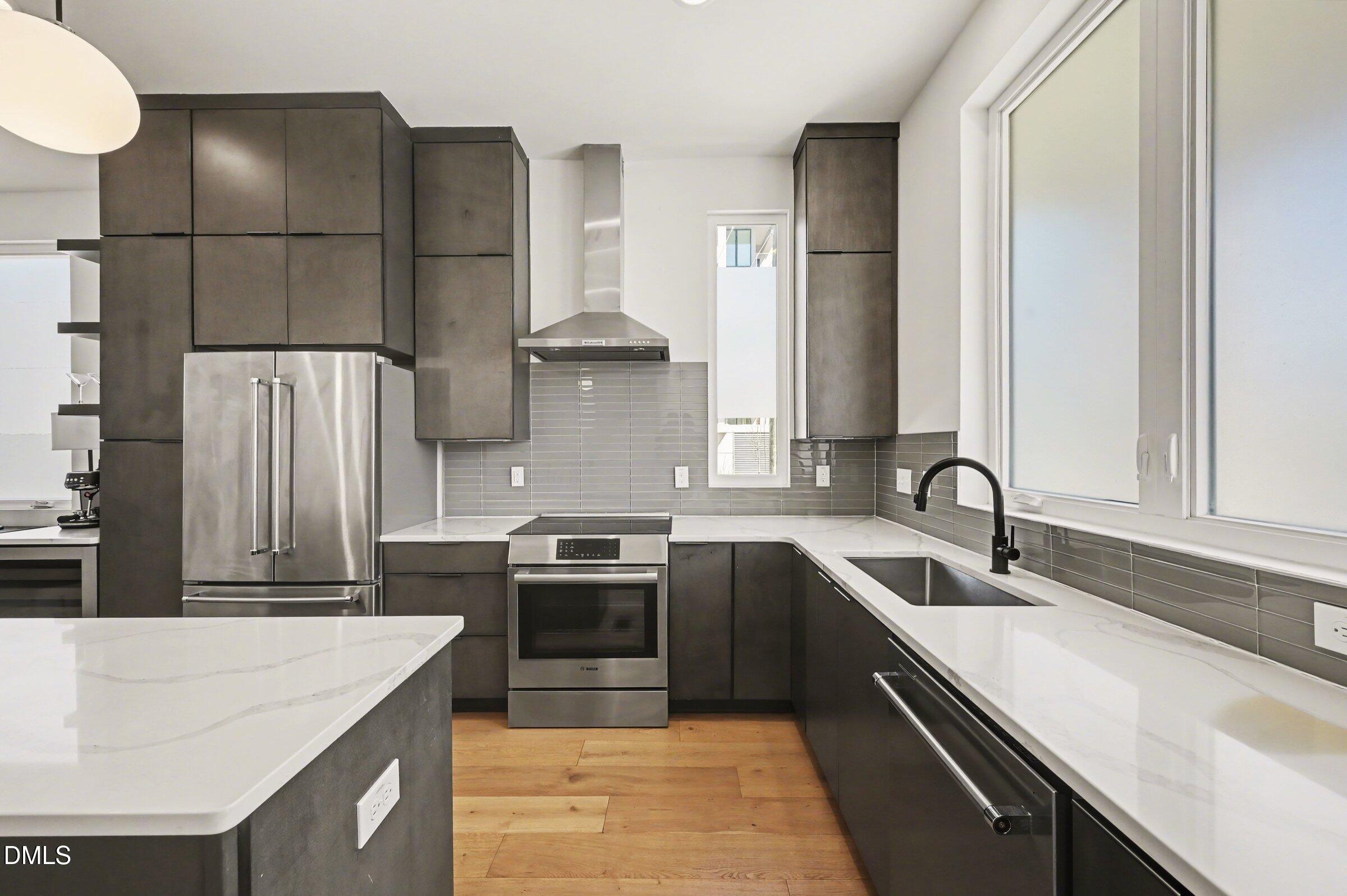 528 North Roxboro Street Durham, NC 27701 - Photo 10 of 26 a kitchen with a sink and a refrigerator