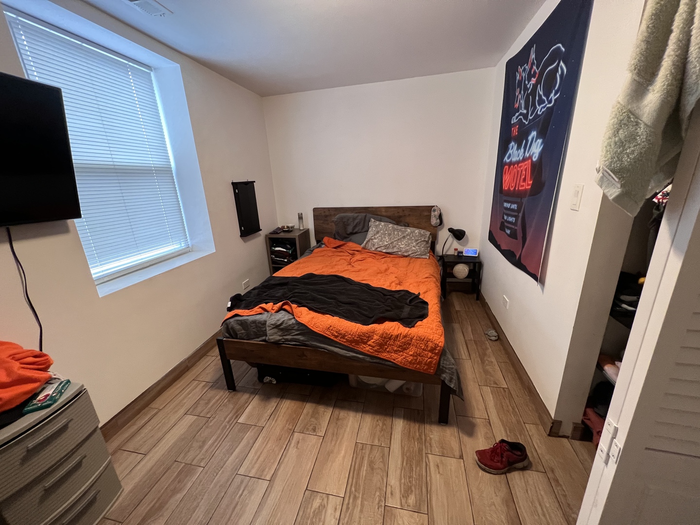 Undisclosed Address Chicago, IL 60618 - Photo 7 of 13 a bedroom with a bed and a flat tv screen on the wall