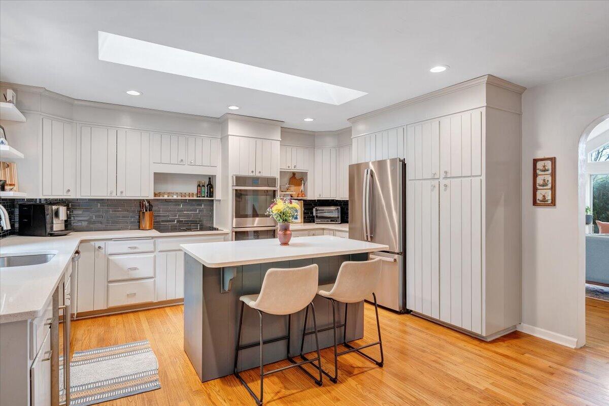 6925 Shaver Road Roanoke, VA 24018 - Photo 24 of 94 a kitchen with stainless steel appliances granite countertop a refrigerator a stove top oven a sink dishwasher and white cabinets with wooden floor