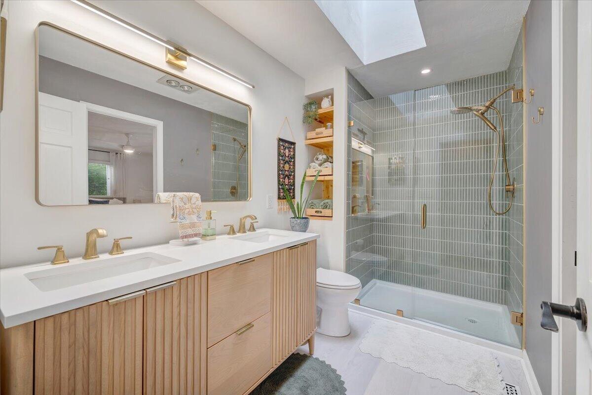 6925 Shaver Road Roanoke, VA 24018 - Photo 54 of 94 a bathroom with a double vanity sink toilet mirror and shower
