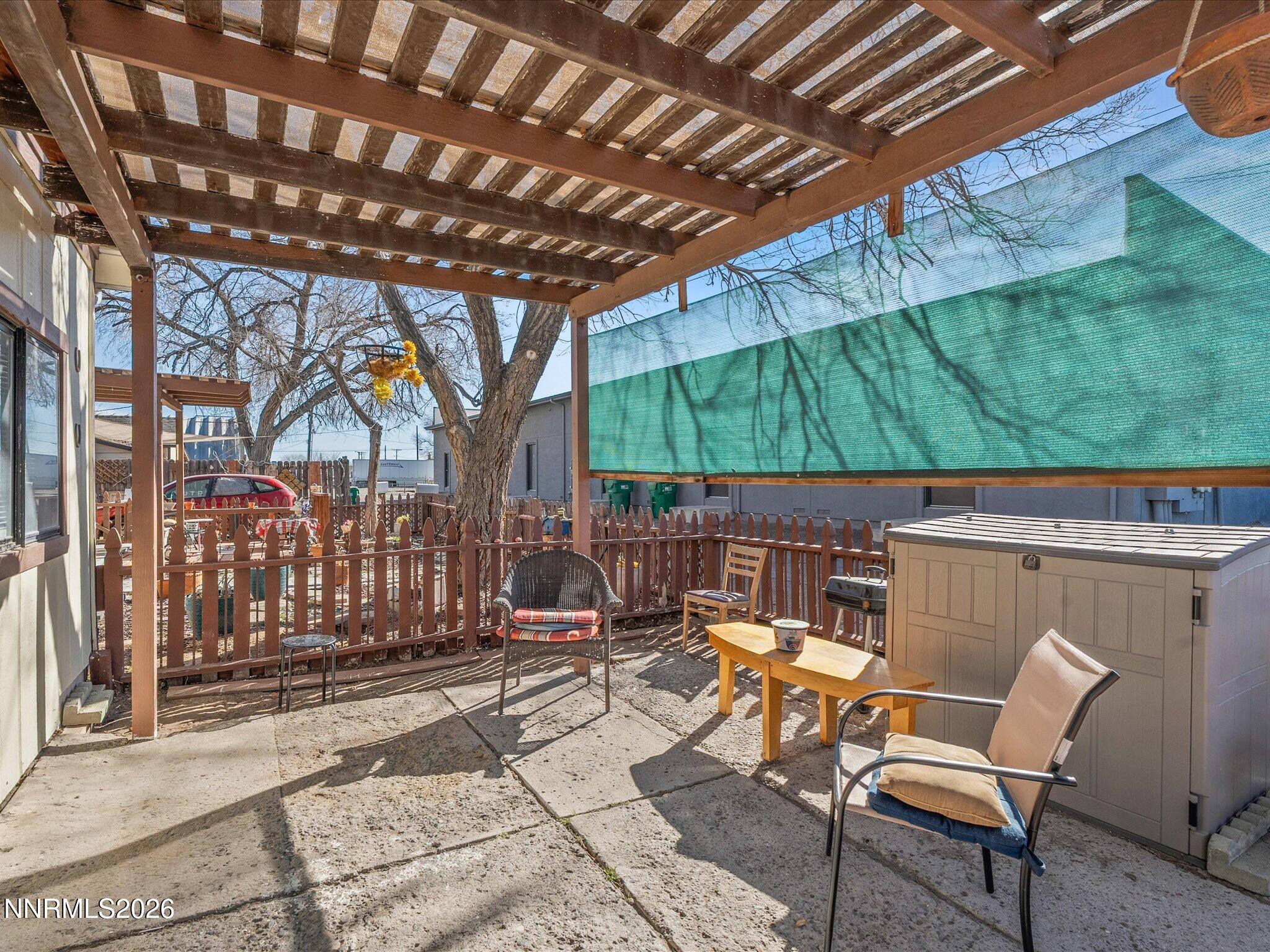 75 South Center Street, Unit A B Fernley, NV 89408 - Photo 13 of 41 a view of a patio with table and chairs with wooden floor