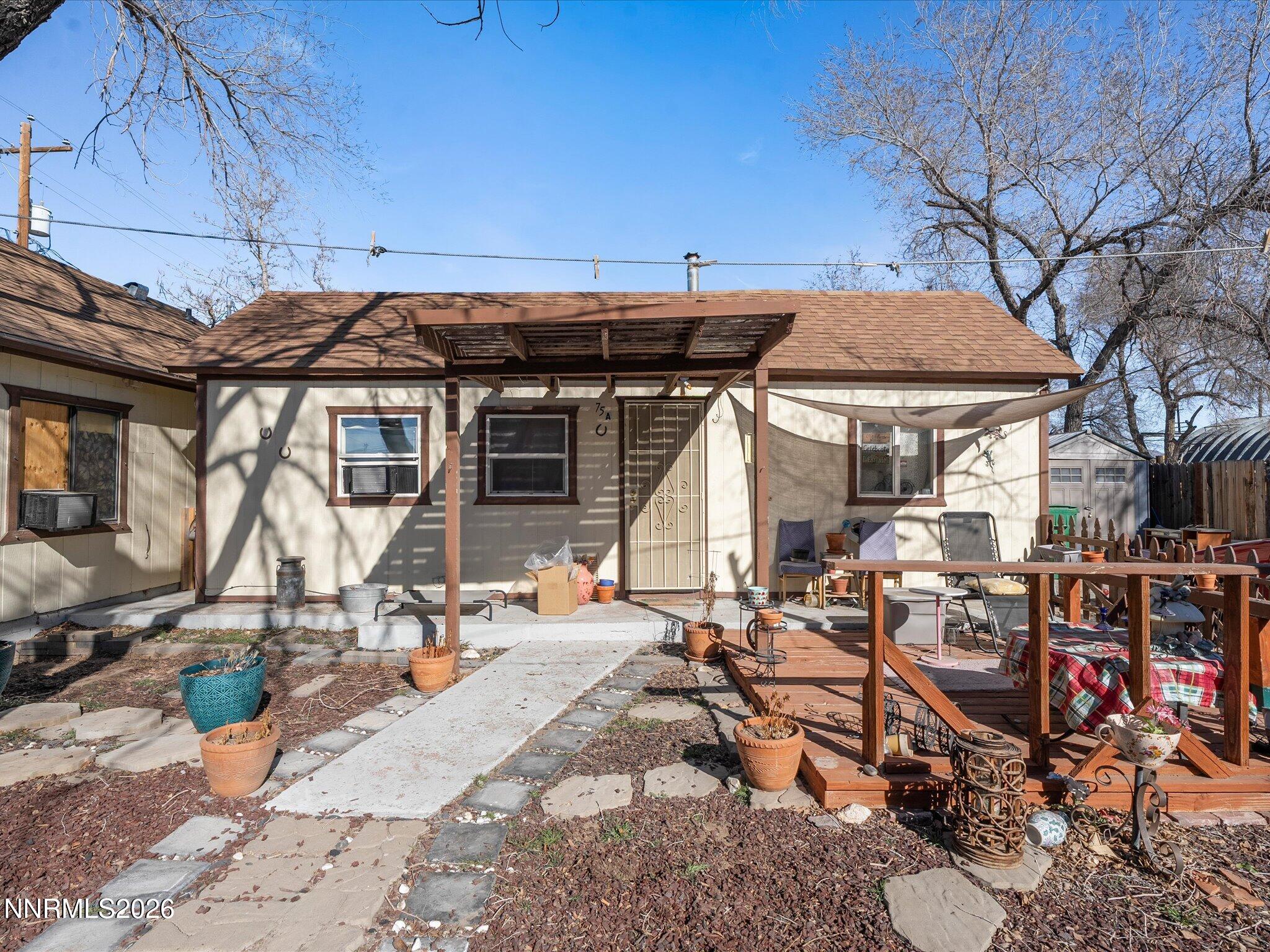 75 South Center Street, Unit A B Fernley, NV 89408 - Photo 14 of 41 a view of a patio with table and chairs under an umbrella