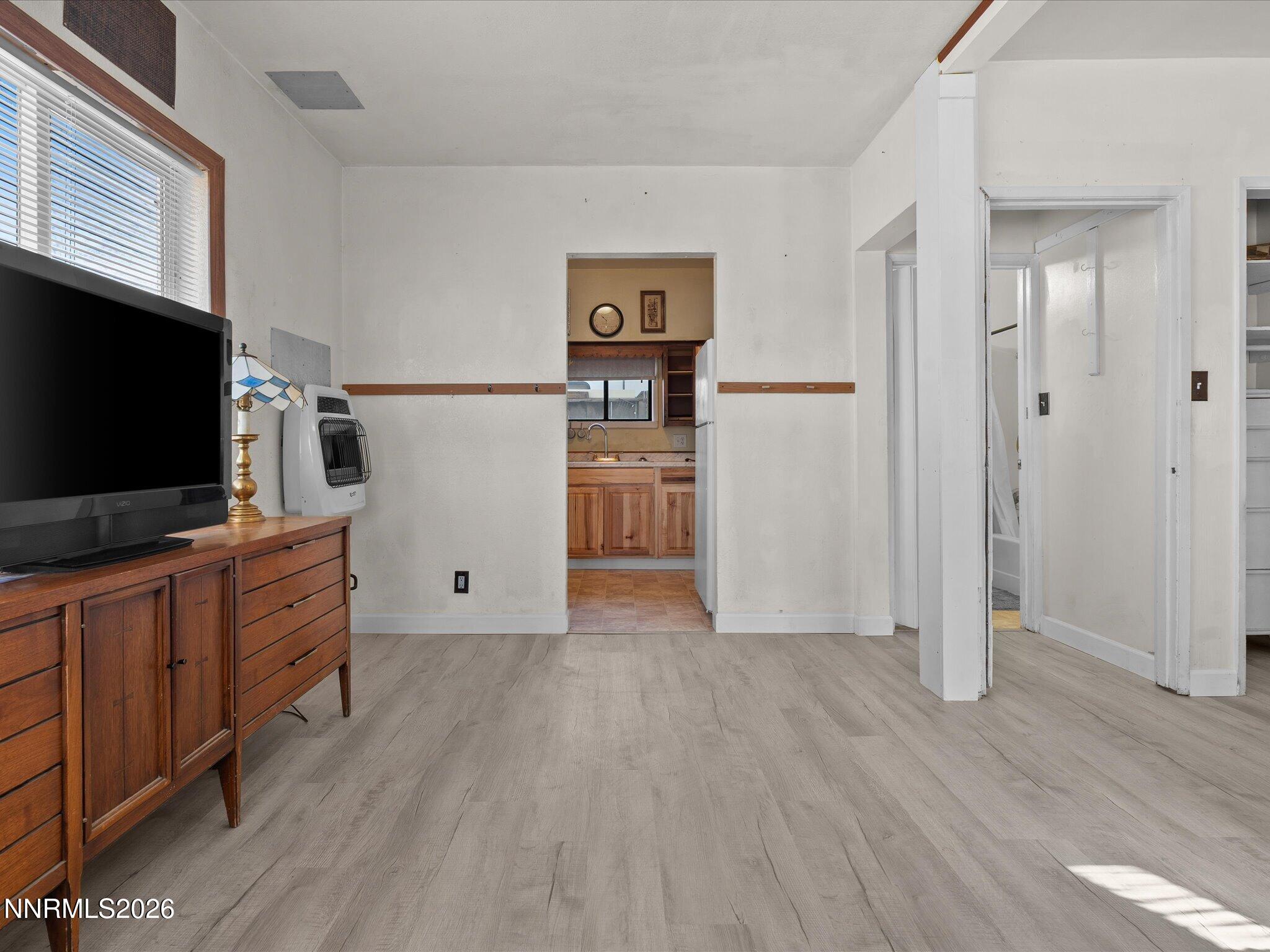 75 South Center Street, Unit A B Fernley, NV 89408 - Photo 18 of 41 an empty room with wooden floor flat screen tv and windows