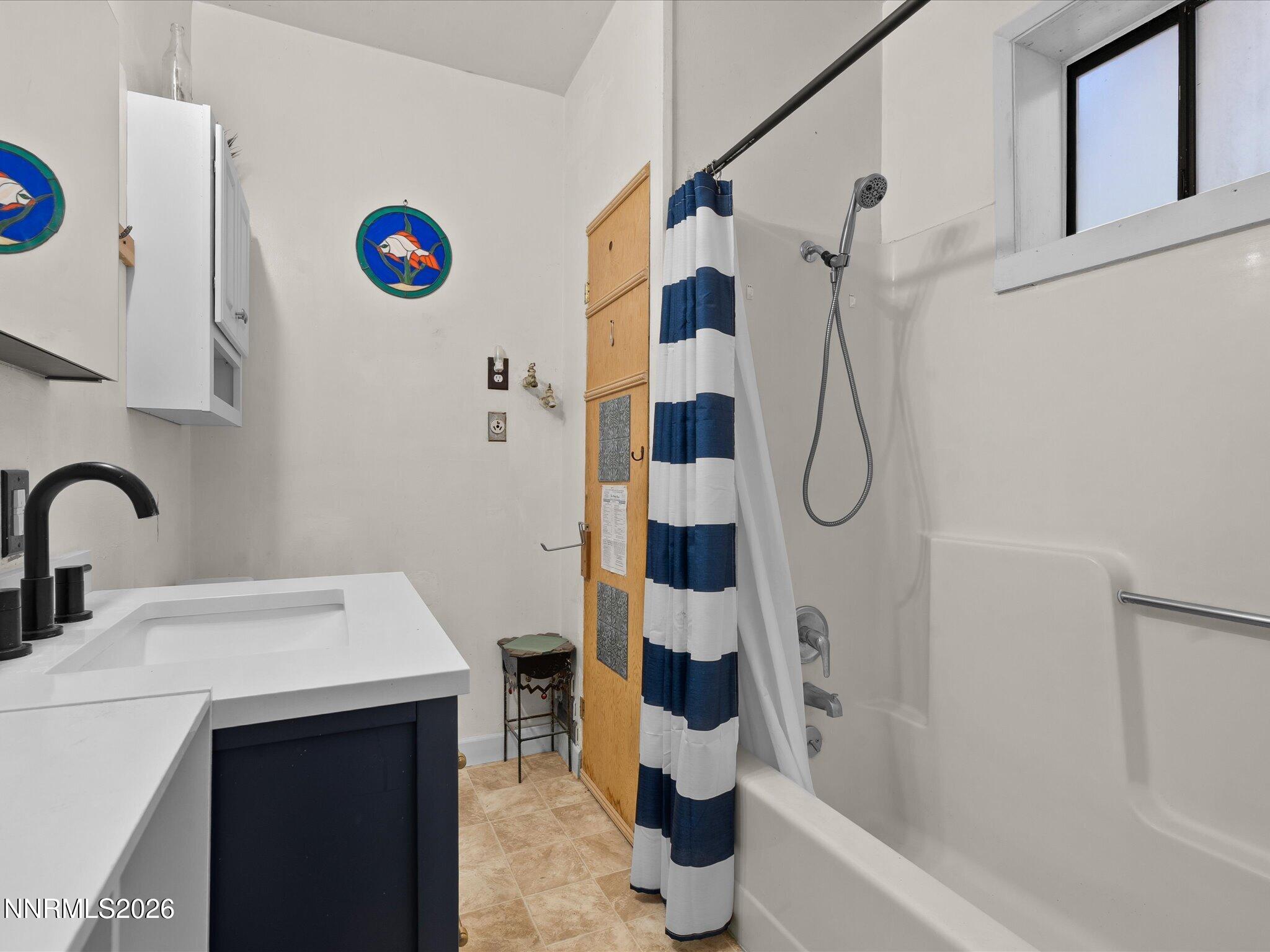 75 South Center Street, Unit A B Fernley, NV 89408 - Photo 25 of 41 a bathroom with a sink a mirror and a shower