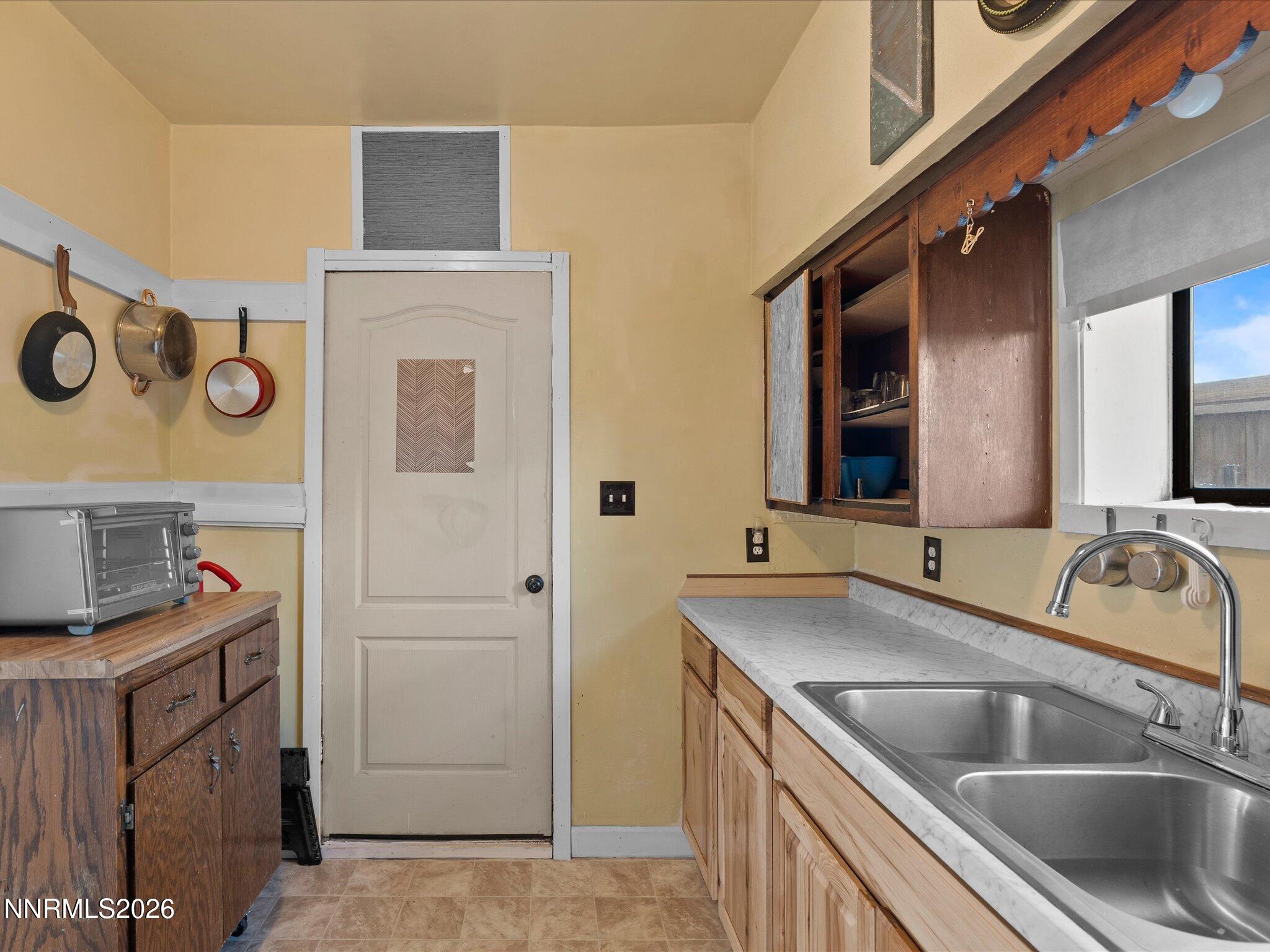 75 South Center Street, Unit A B Fernley, NV 89408 - Photo 28 of 41 a kitchen with a sink and a refrigerator