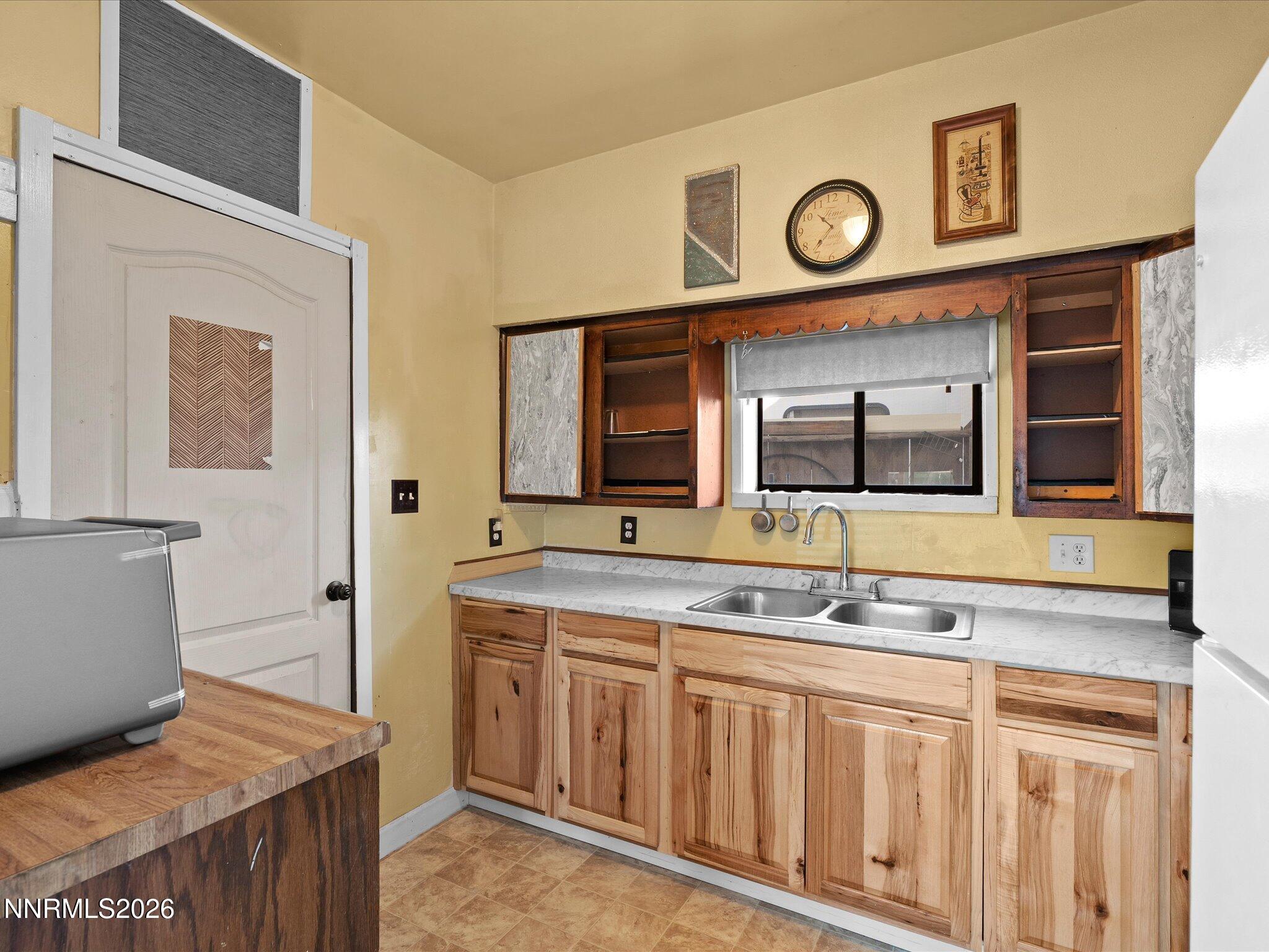 75 South Center Street, Unit A B Fernley, NV 89408 - Photo 30 of 41 a bathroom with a granite countertop sink and a mirror