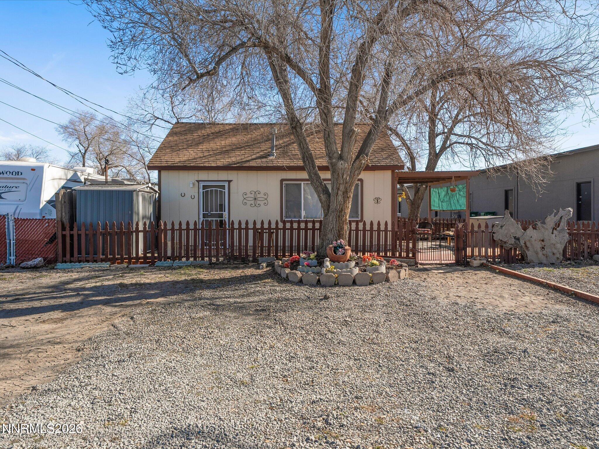 75 South Center Street, Unit A B Fernley, NV 89408 - Photo 3 of 41 a view of a house with a large tree and wooden fence