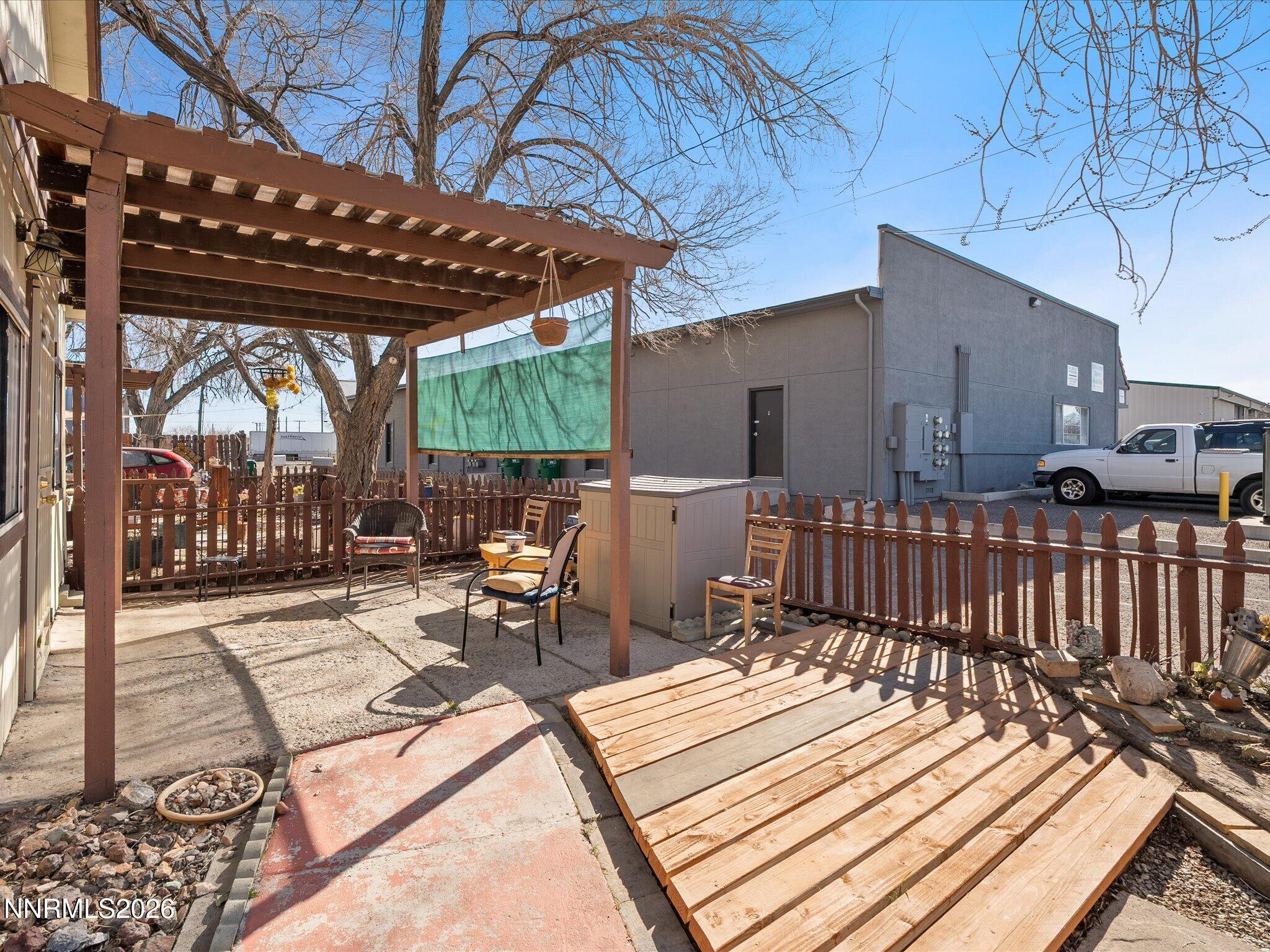 75 South Center Street, Unit A B Fernley, NV 89408 - Photo 10 of 41 a view of a patio with table and chairs with wooden floor and fence