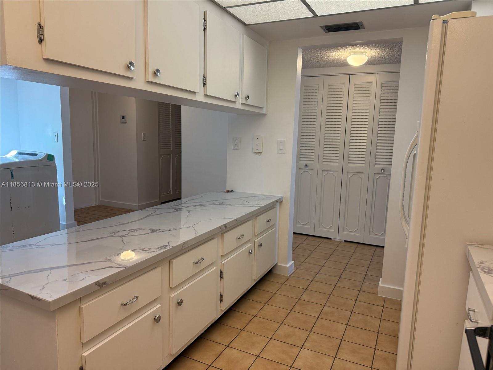 20441 Northeast 30th Avenue, Unit 1129 Aventura, FL 33180 - Photo 14 of 16 a bathroom with a granite countertop sink and a mirror