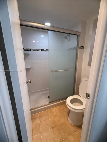 a bathroom with a shower and a toilet