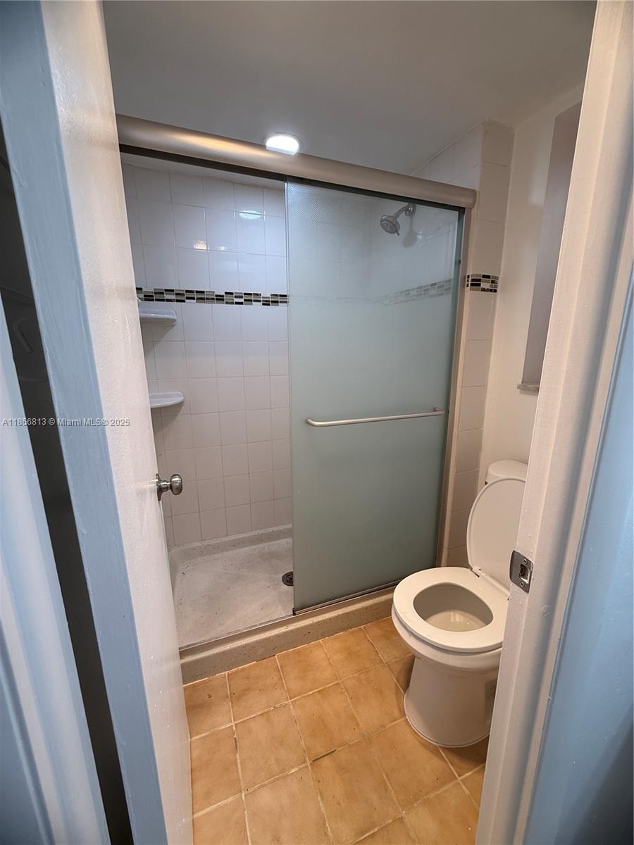 20441 Northeast 30th Avenue, Unit 1129 Aventura, FL 33180 - Photo 2 of 16 a bathroom with a shower and a toilet