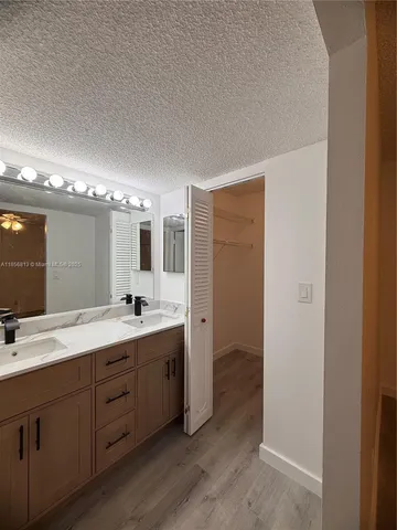 a bathroom with a double vanity sink and mirror