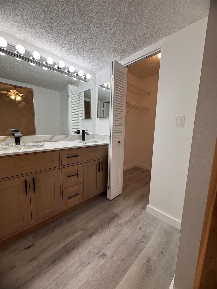 20441 Northeast 30th Avenue, Unit 1129 Aventura, FL 33180 - Photo 4 of 16 a spacious bathroom with a double vanity sink a large mirror and a shower