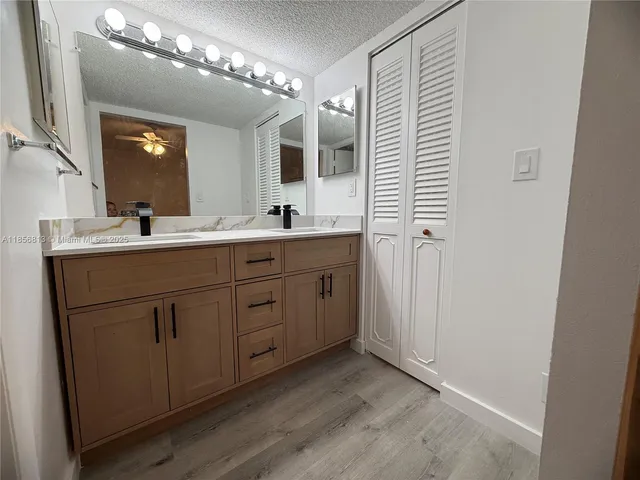 a bathroom with a double vanity sink and mirror