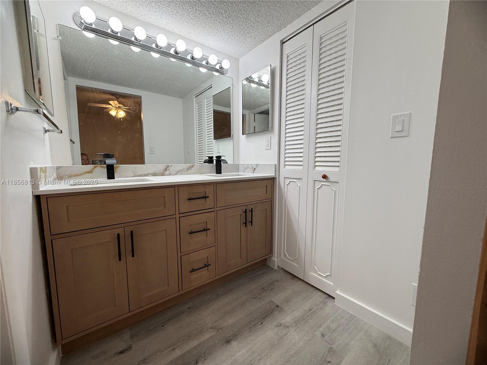 20441 Northeast 30th Avenue, Unit 1129 Aventura, FL 33180 - Photo 5 of 16 a bathroom with a double vanity sink and mirror