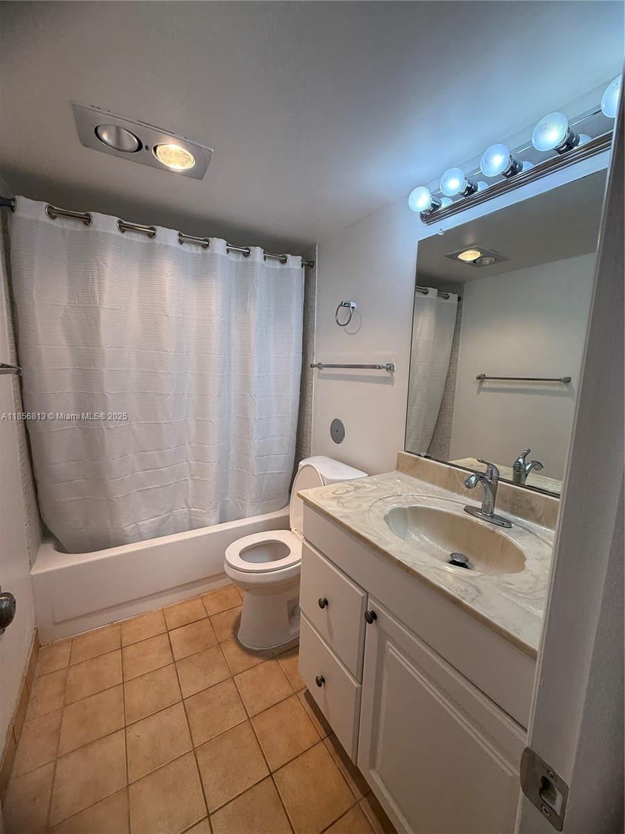 20441 Northeast 30th Avenue, Unit 1129 Aventura, FL 33180 - Photo 7 of 16 a bathroom with a granite countertop sink toilet and shower