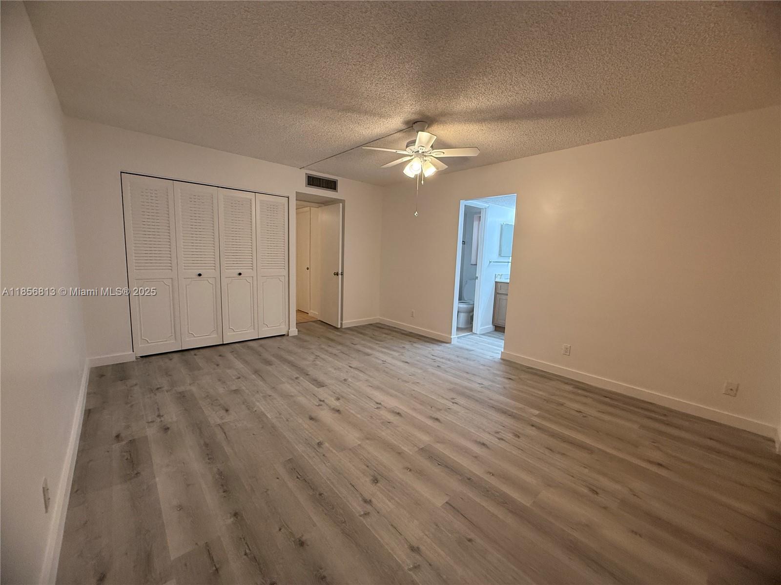 20441 Northeast 30th Avenue, Unit 1129 Aventura, FL 33180 - Photo 9 of 16 a view of empty room with wooden floor