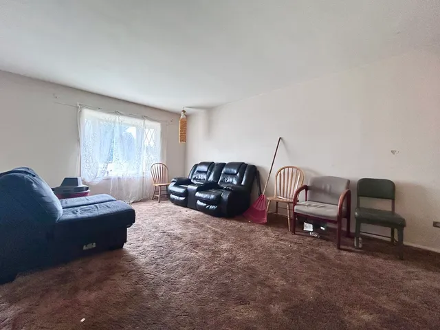 a living room with furniture a couch and a window