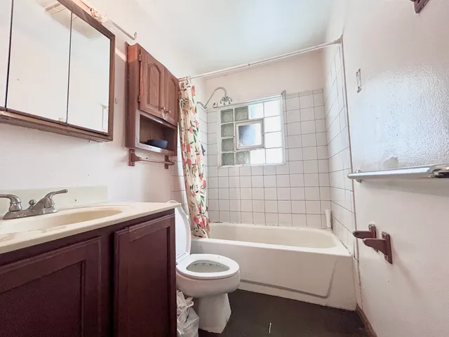 a bathroom with a sink a toilet and bathtub