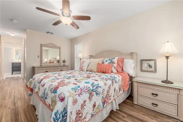 a bedroom with a large bed and a chandelier