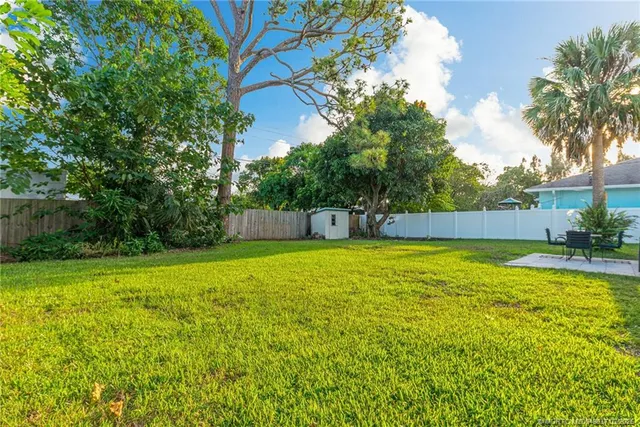 a swimming pool with lots of tress in front of it