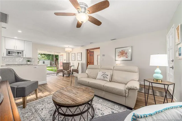 a living room with furniture a lamp and a window