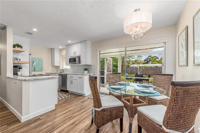 a kitchen with a table chairs stove and cabinets