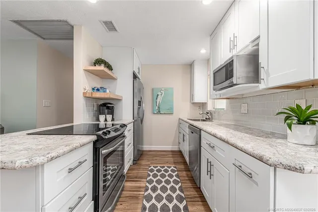 a kitchen with granite countertop a sink and stove